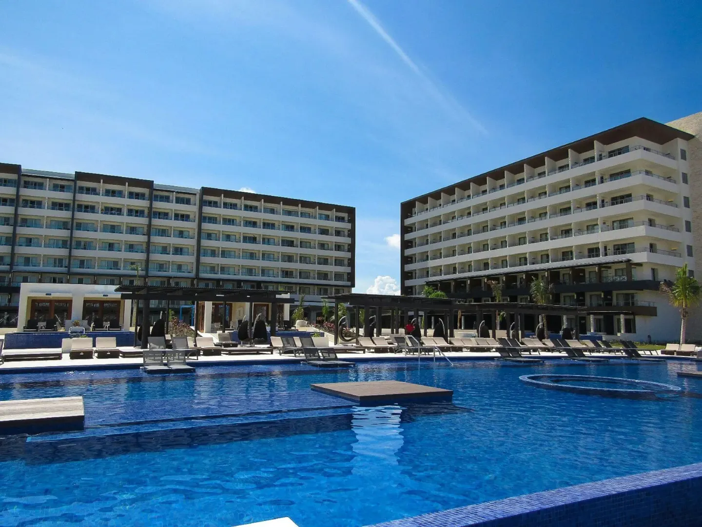 A large pool sits between guest buildings at Royalton Blue Waters Montego Bay.