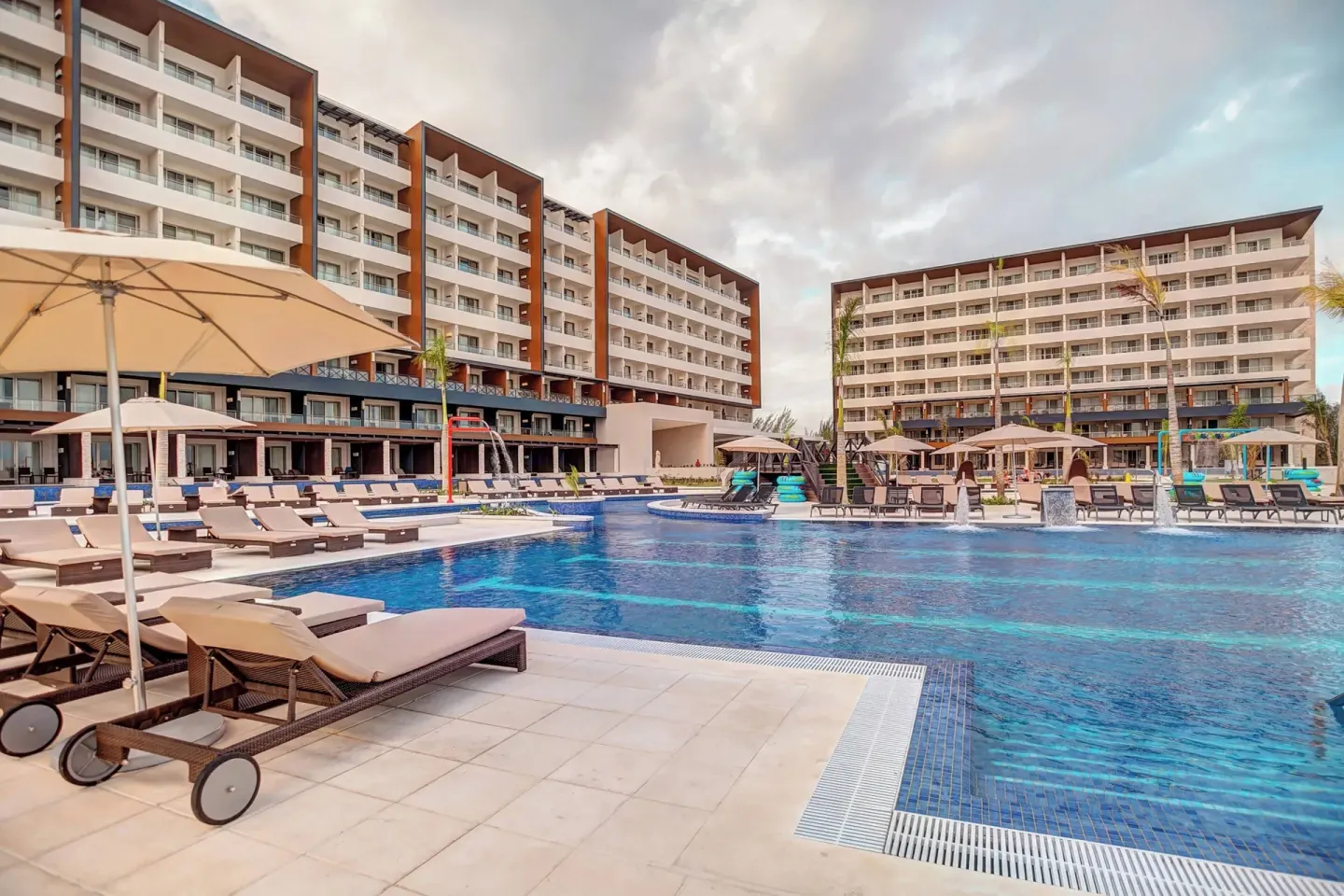 Resort pool with loungers, umbrellas, and guest room blocks at Royalton Blue Waters Montego Bay.