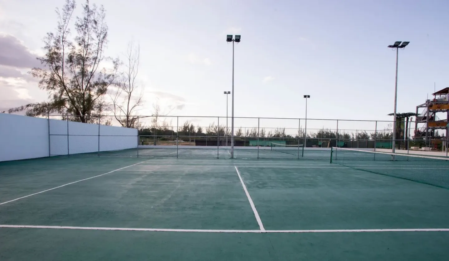 Outdoor tennis court with lights at Royalton Blue Waters Montego Bay.