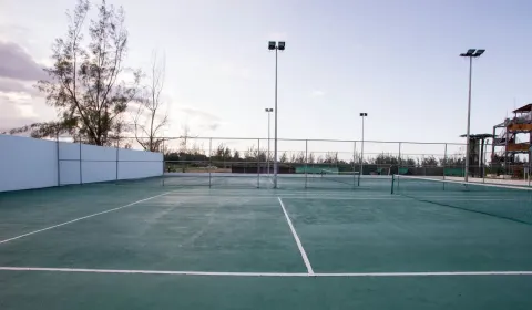 Outdoor tennis court with lights at Royalton Blue Waters Montego Bay.