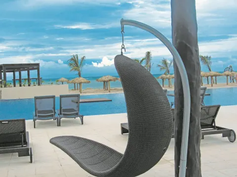 Hanging chair overlooks the pool, beach, and ocean at Royalton Blue Waters Montego Bay.