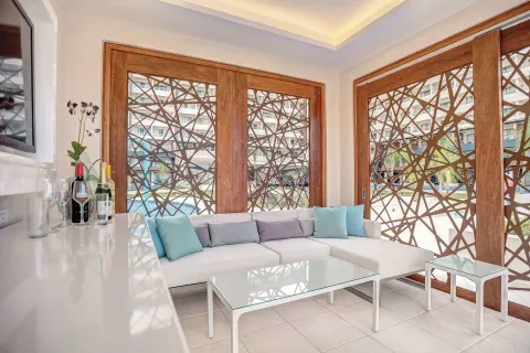 Bright lounge with white seating and patterned wood screens at Royalton Blue Waters Montego Bay.