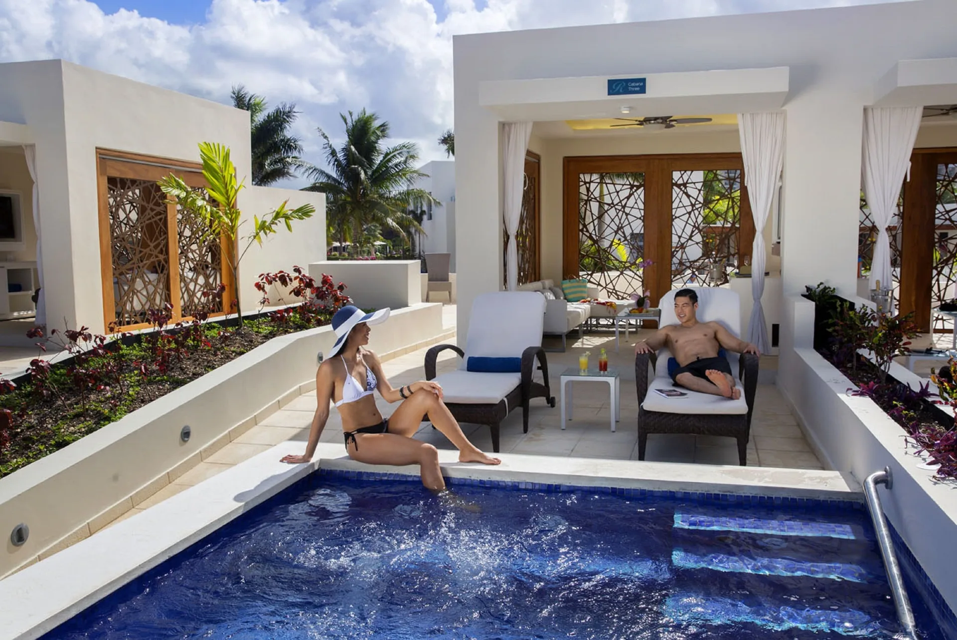 Guests relax beside a swim-up pool terrace at Royalton Blue Waters Montego Bay.