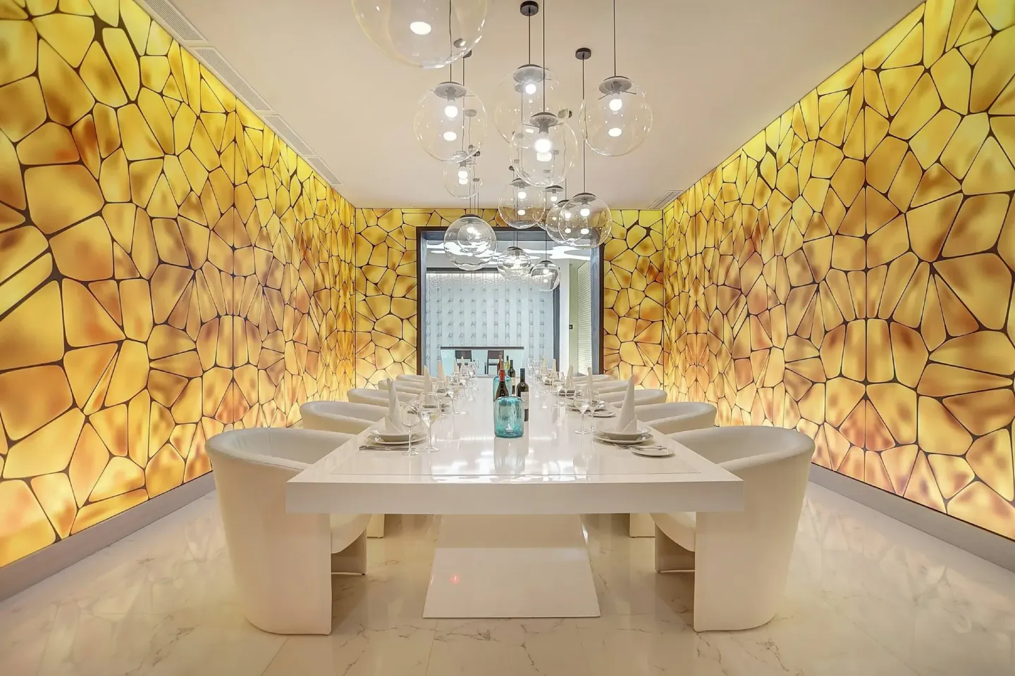 Private dining table with golden wall panels at Royalton Blue Waters Montego Bay.
