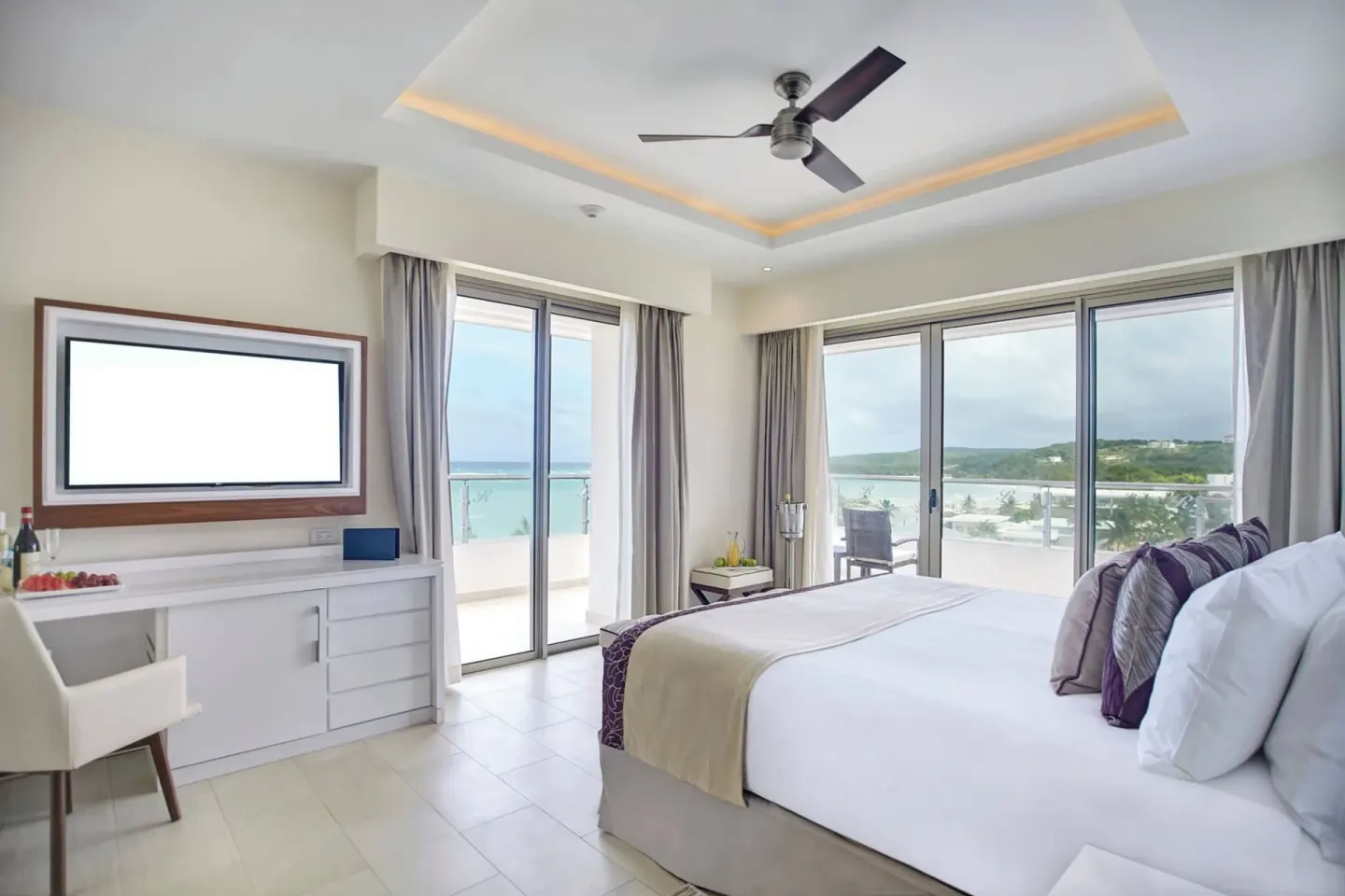 Presidential one bedroom ocean view suite with king bed at Royalton Blue Waters Montego Bay.