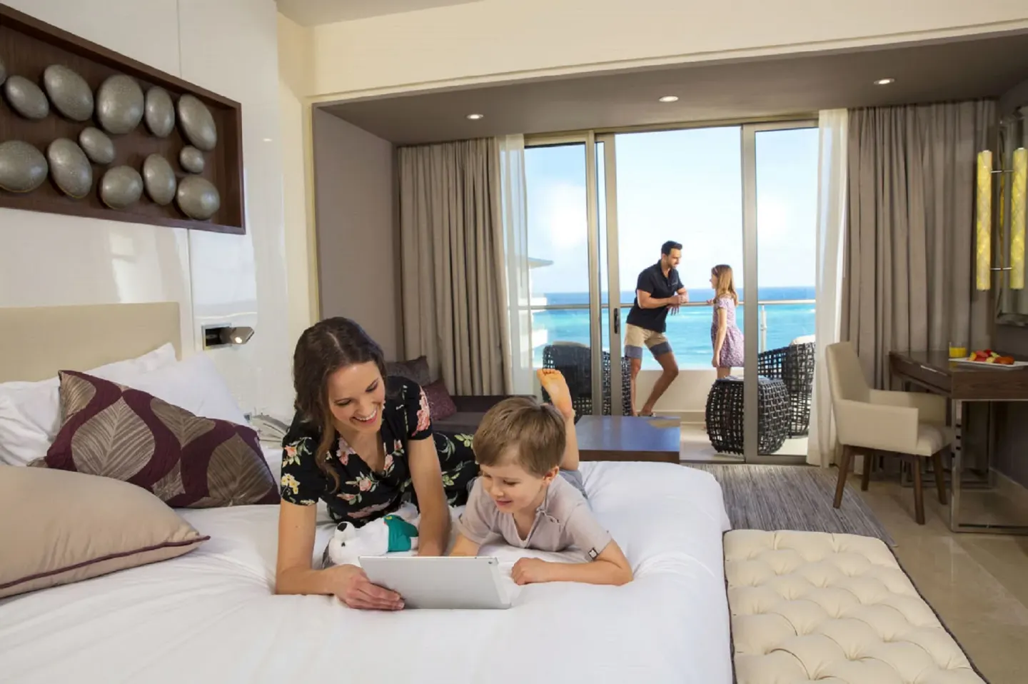 Two-bedroom suite bedroom with ocean-facing balcony at Royalton Blue Waters Montego Bay.