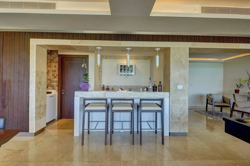 Suite wet bar with three stools at Royalton Blue Waters Montego Bay.
