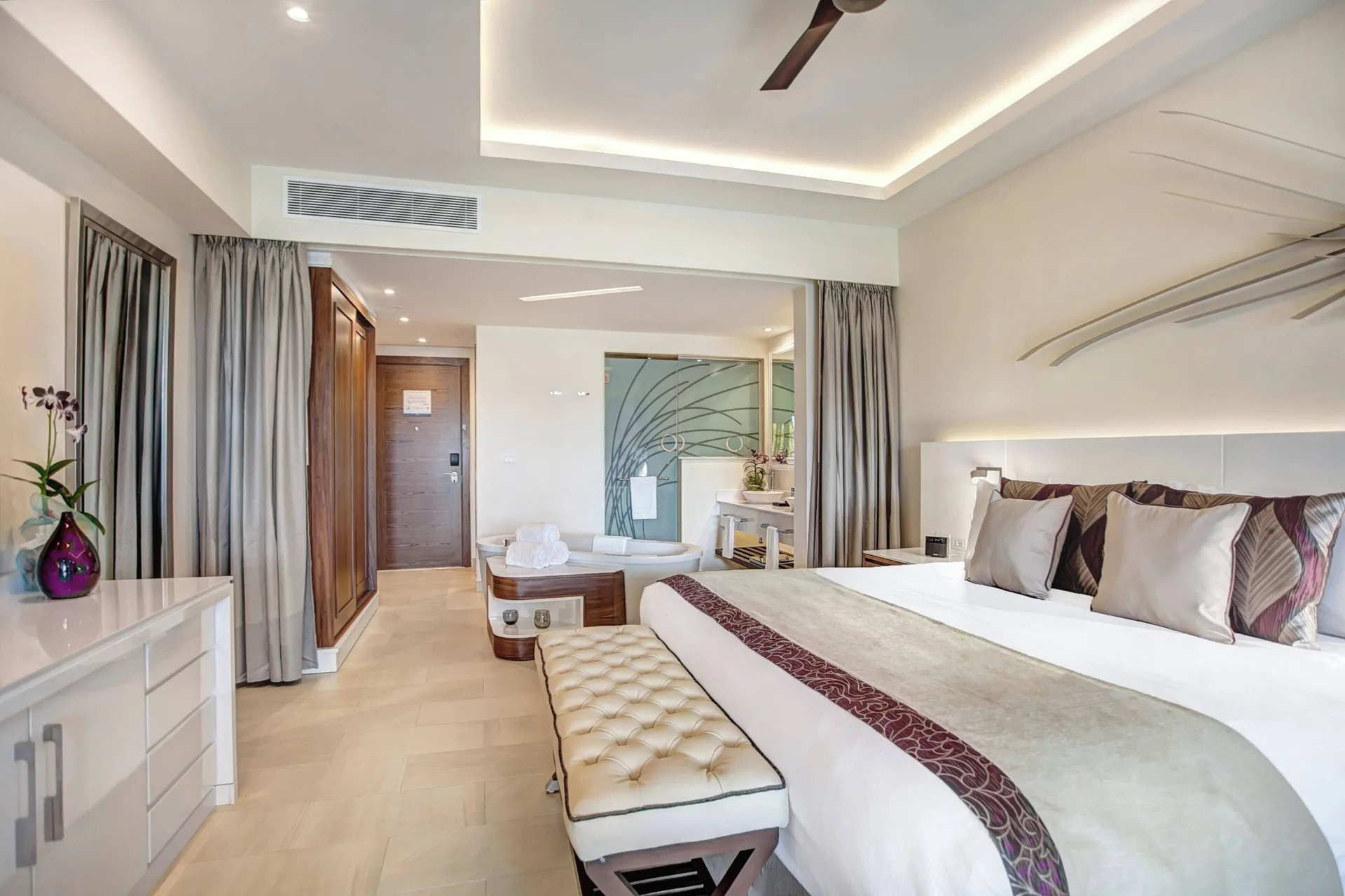 King bed and open bath area in a Luxury Junior Suite at Royalton Blue Waters Montego Bay.