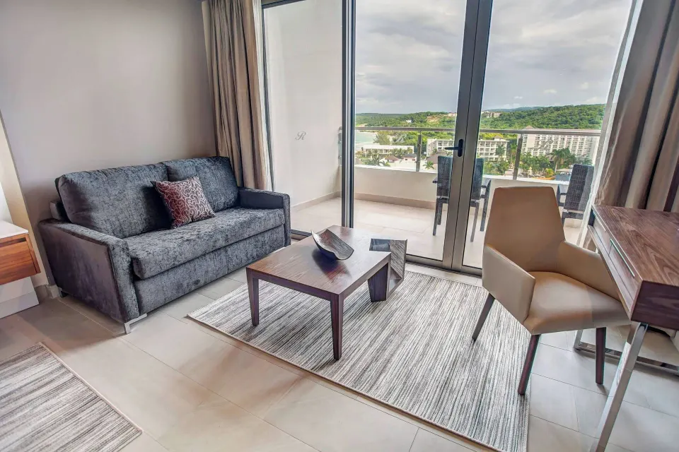 Sitting area in a Luxury Junior Suite Ocean View at Royalton Blue Waters Montego Bay.