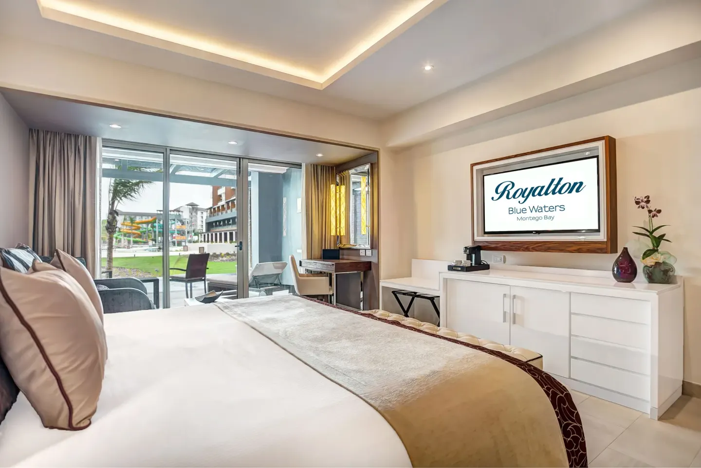 Luxury Junior Suite Swim Out bedroom with patio at Royalton Blue Waters Montego Bay.