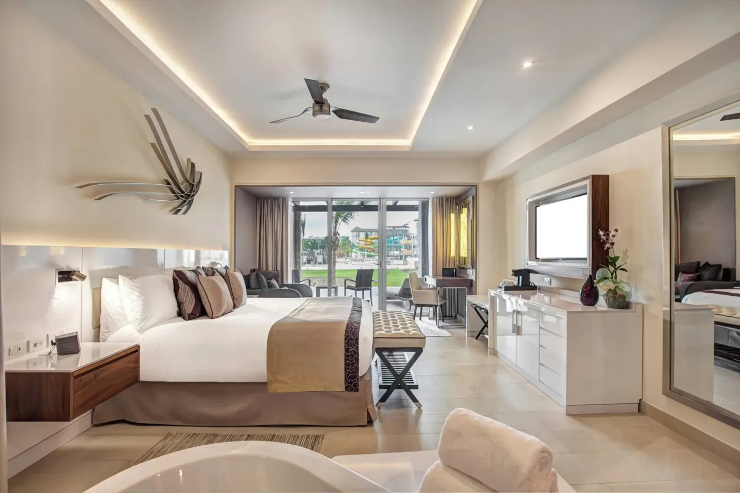 Luxury Junior Suite king bed and open bath area at Royalton Blue Waters Montego Bay.