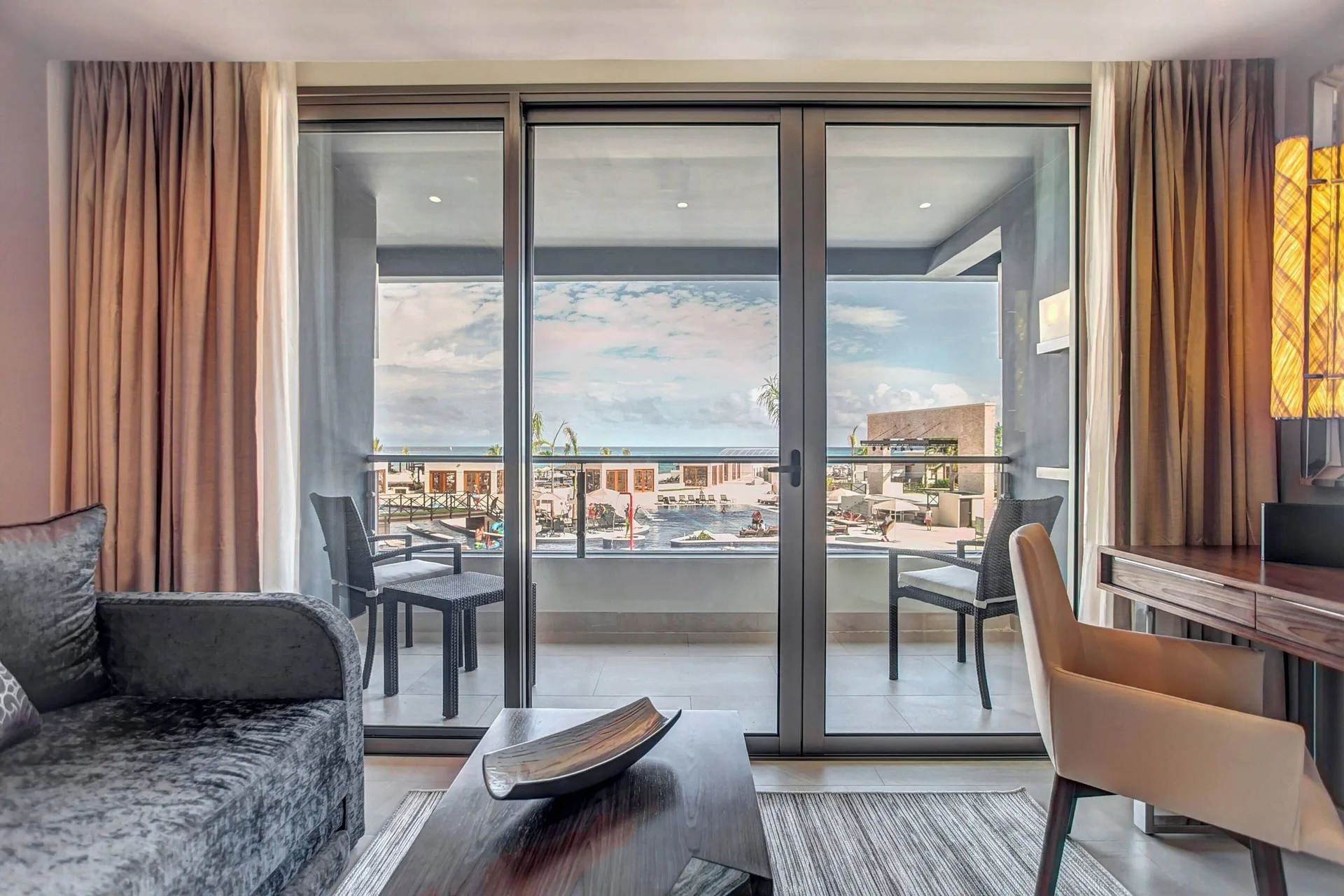 Luxury Junior Suite sitting area and balcony at Royalton Blue Waters Montego Bay.