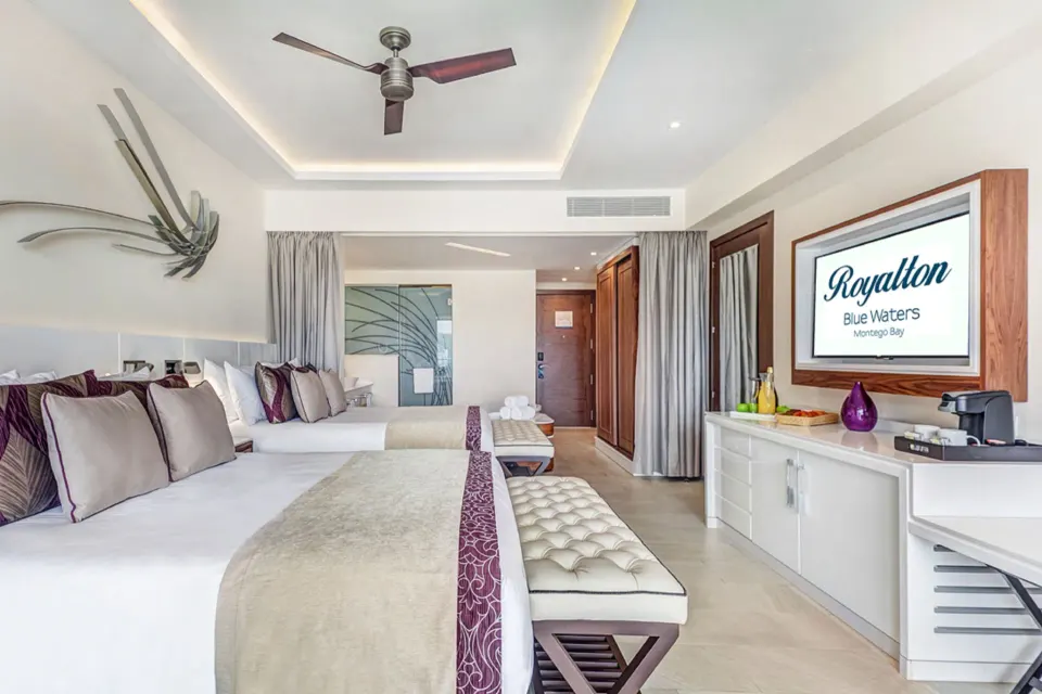 Luxury Junior Suite with two beds and TV at Royalton Blue Waters Montego Bay.