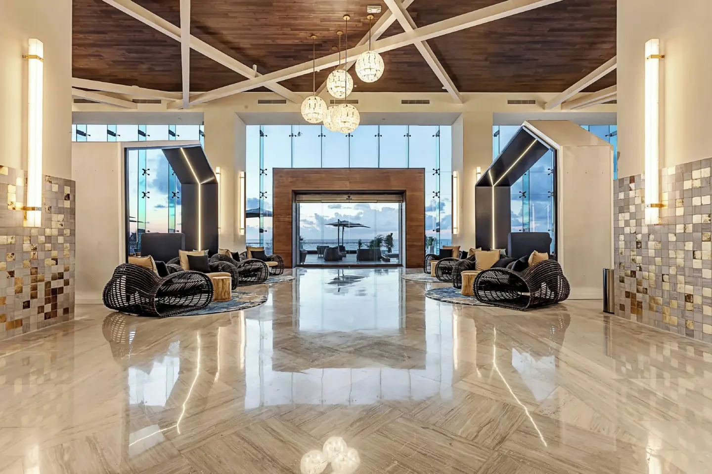 Grand lobby corridor with seating and ocean view at Royalton CHIC Cancun.
