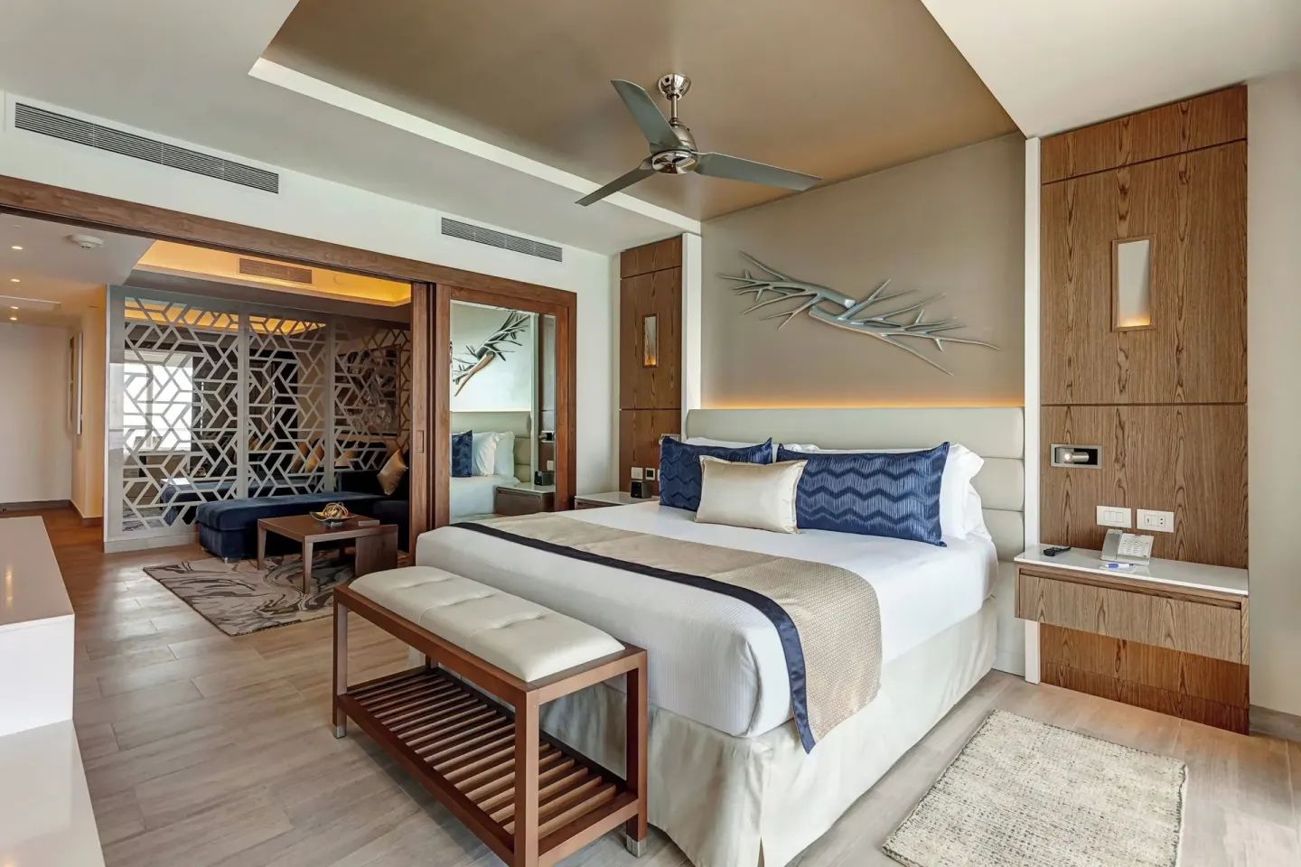 Guest room with king bed and lounge area at Royalton CHIC Cancun.