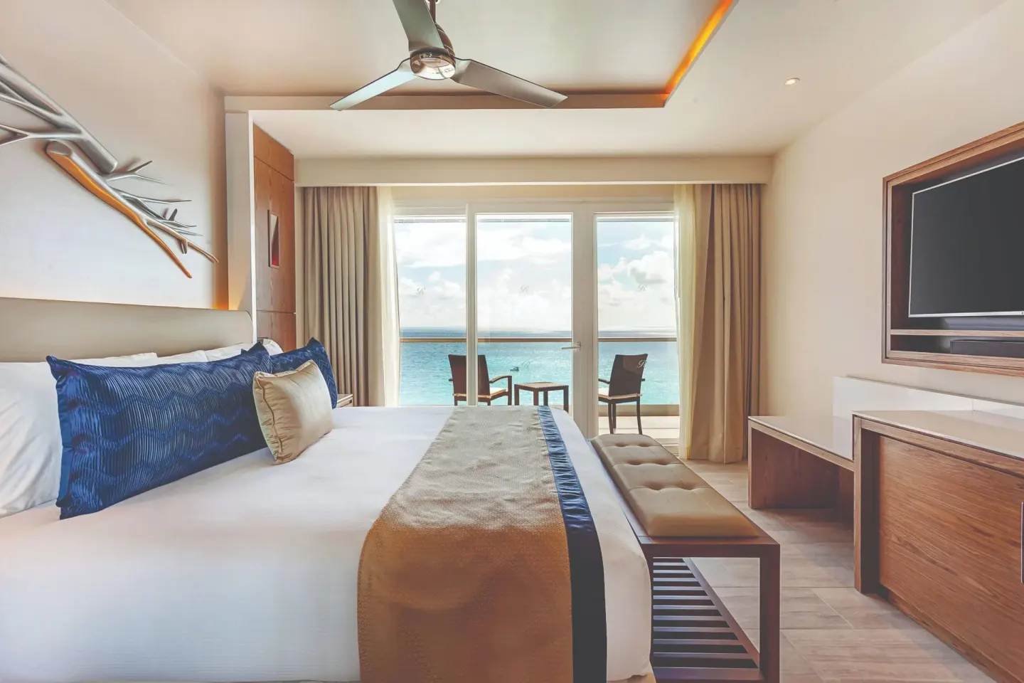 King bed guest room with ocean-facing balcony at Royalton CHIC Cancun.