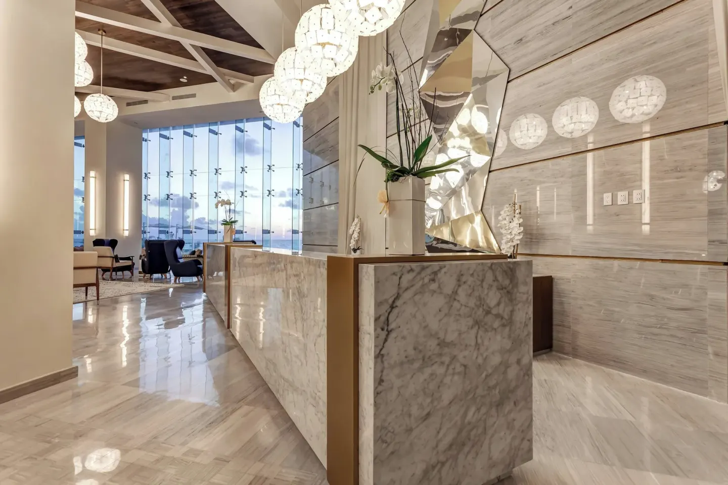 Marble lobby console with orchid arrangement at Royalton CHIC Cancun.