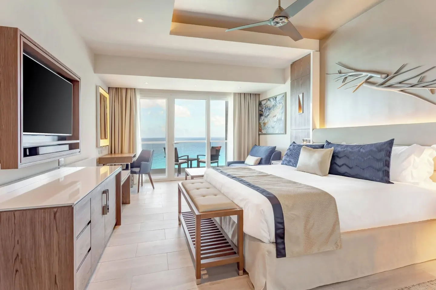 Ocean-view king guest room with balcony at Royalton CHIC Cancun.