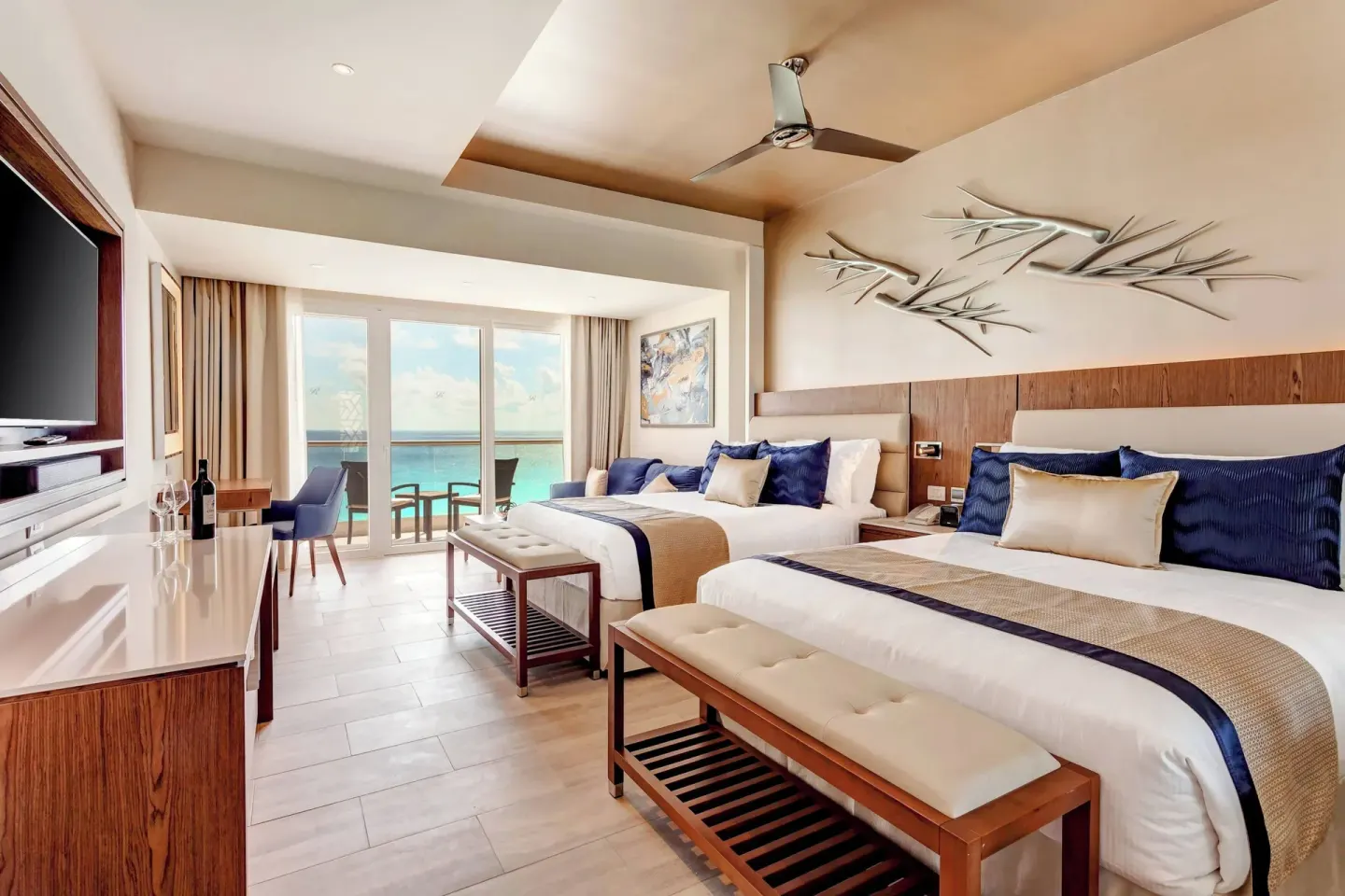 Ocean-view guest room with two beds at Royalton CHIC Cancun.