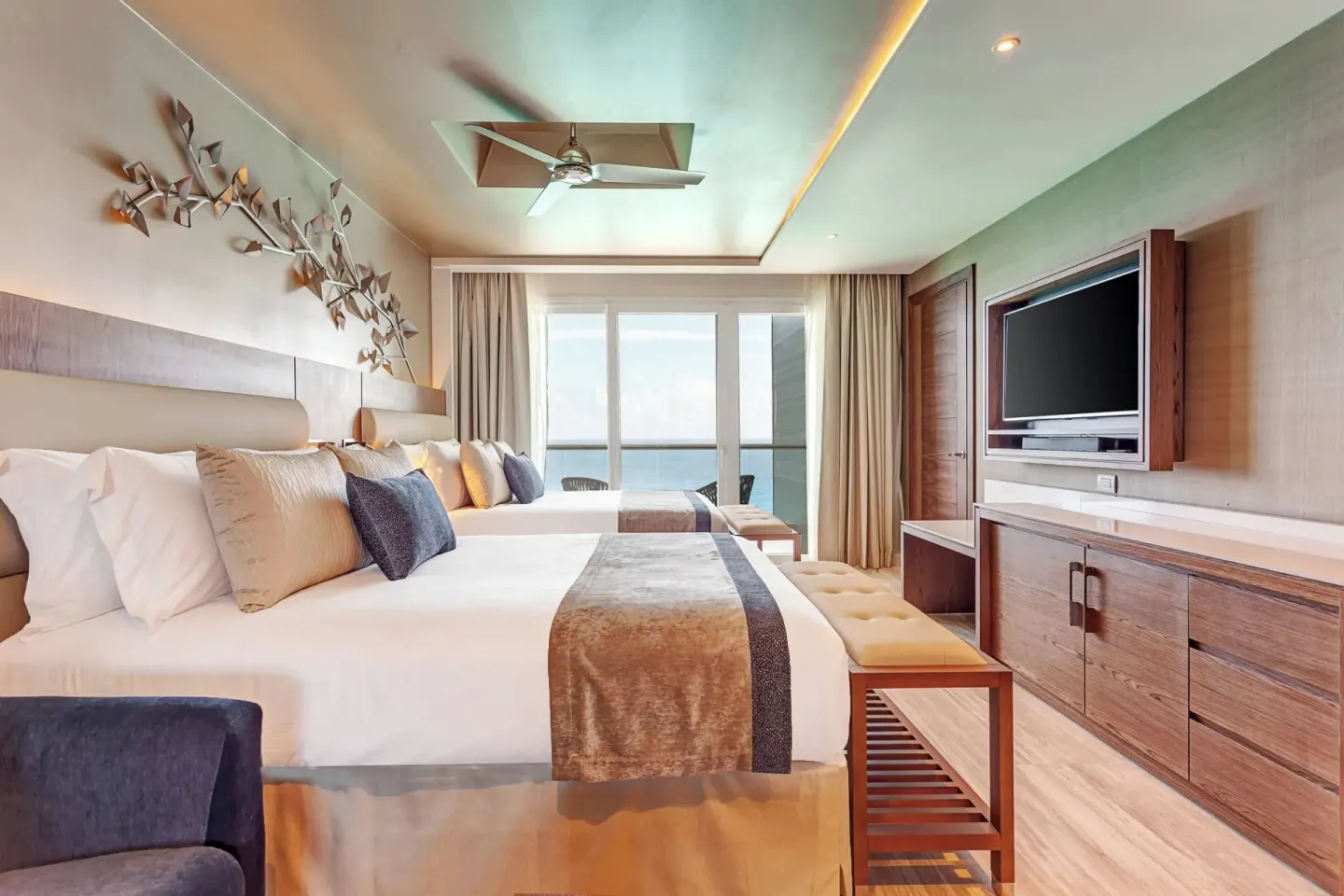 Two-bed ocean-view guest room with balcony at Royalton CHIC Cancun.