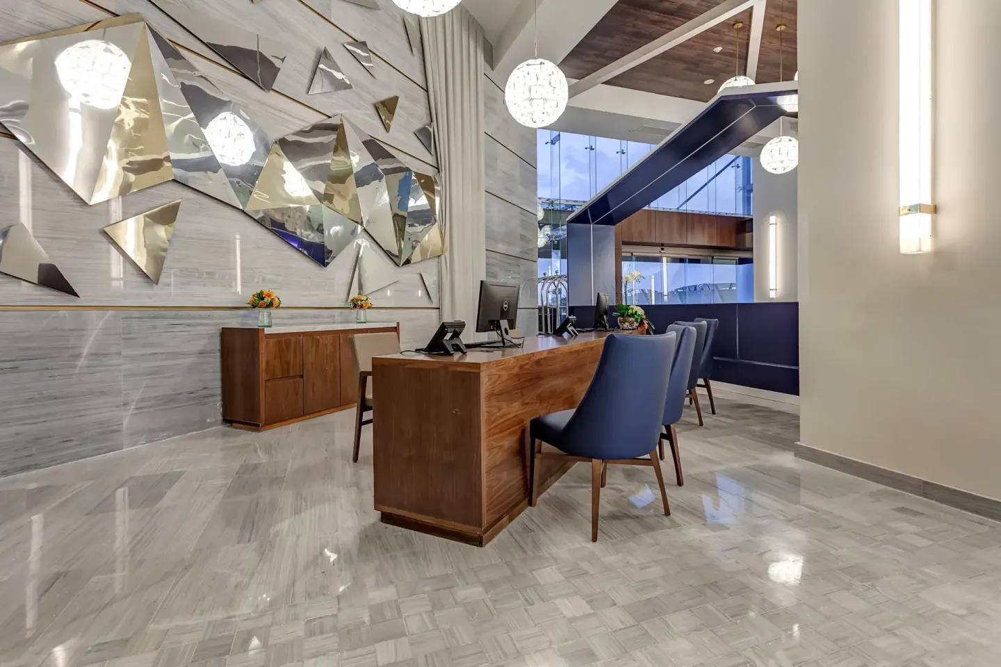 Reception desk with metallic wall art at Royalton CHIC Cancun.