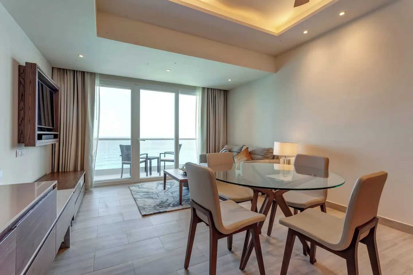 Suite dining and living area with ocean-view balcony at Royalton CHIC Cancun.