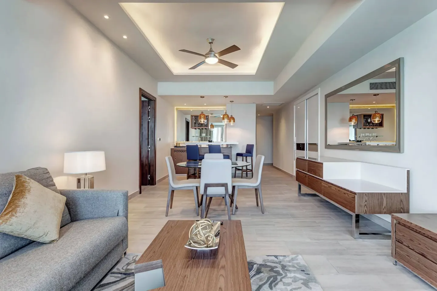 Suite living and dining area with kitchenette at Royalton CHIC Cancun.
