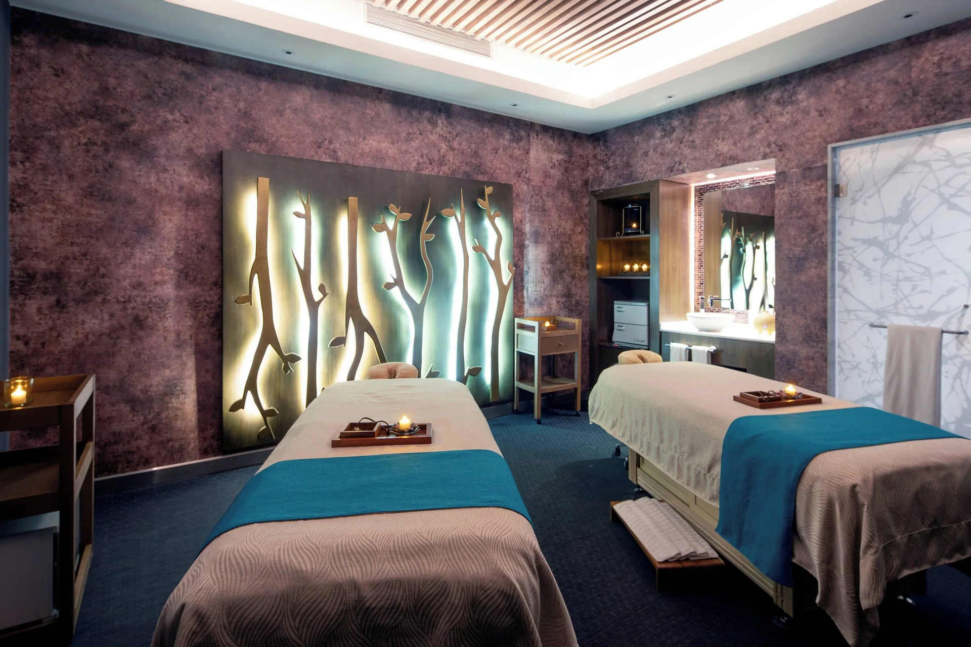 Twin spa treatment beds in a softly lit room at Royalton CHIC Cancun.
