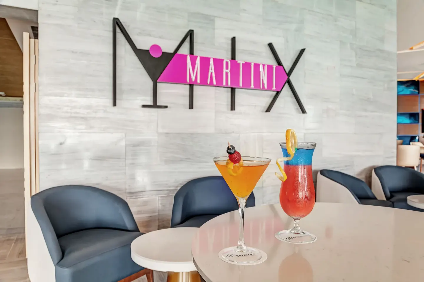 Martini Mix sign with two cocktails on a lounge table at Royalton CHIC Cancun.