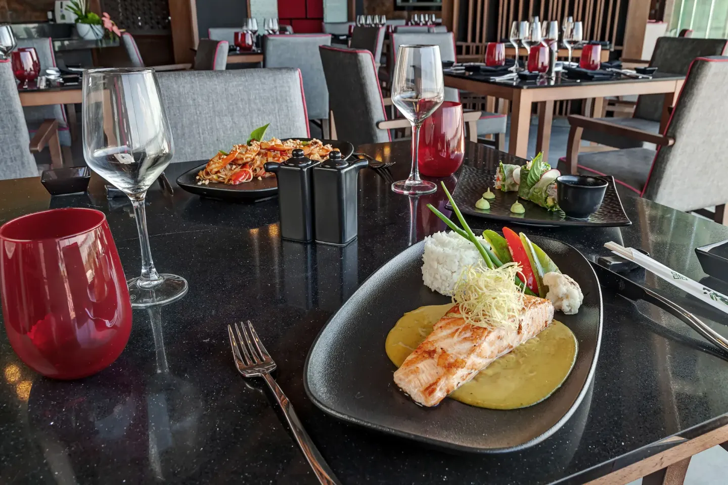 Plated seafood and sushi dishes on a restaurant table at Royalton CHIC Cancun.