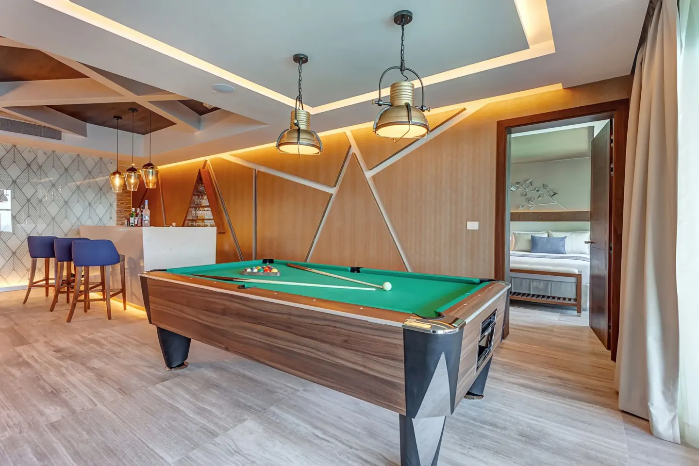 Game room with pool table and bar in a Chairman's suite at Royalton CHIC Cancun.