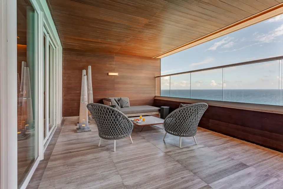 Oceanfront terrace seating in a Chairman's suite at Royalton CHIC Cancun.