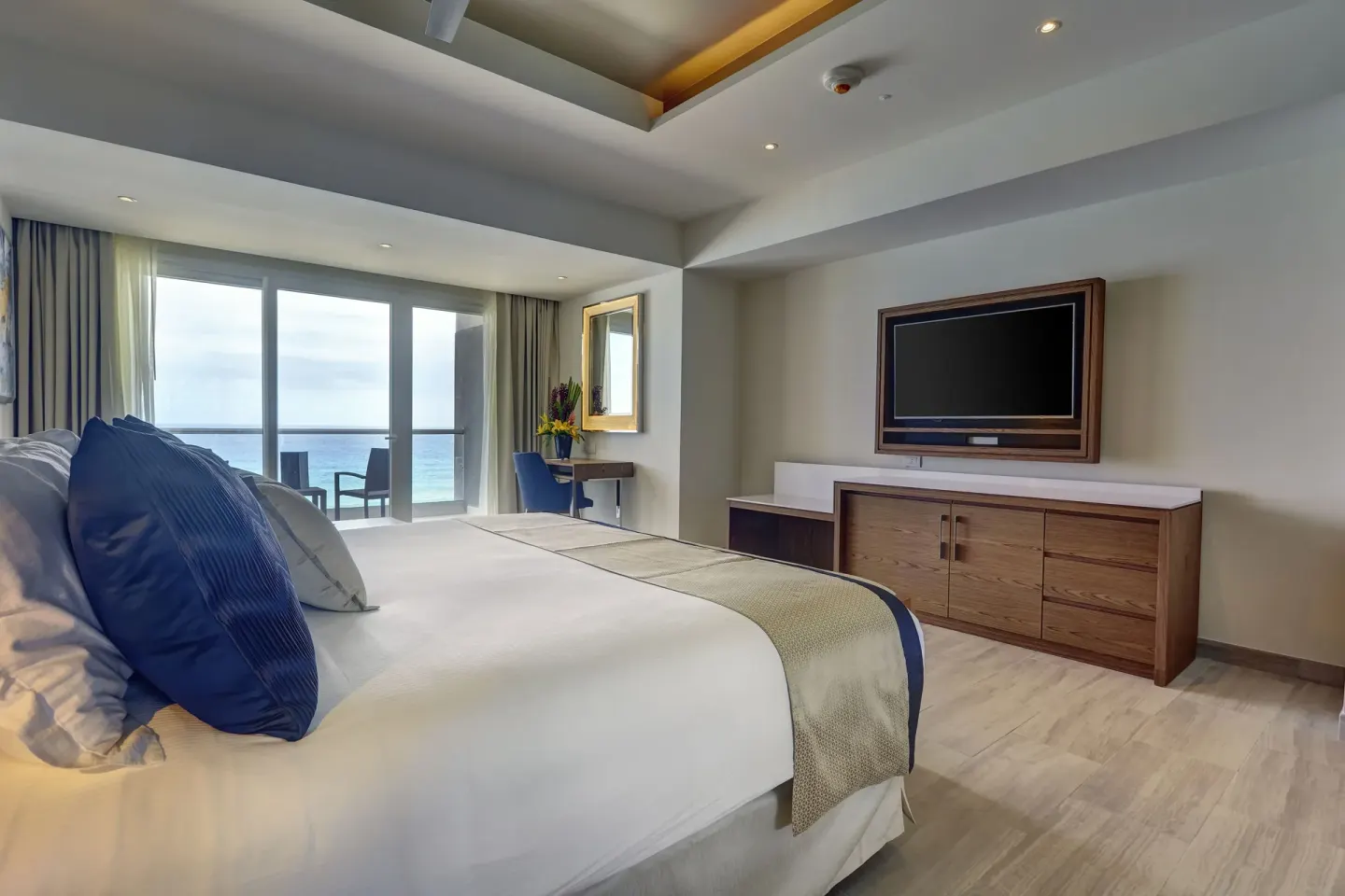 Luxury Junior Suite Ocean Front king bed and ocean-facing balcony at Royalton CHIC Cancun.