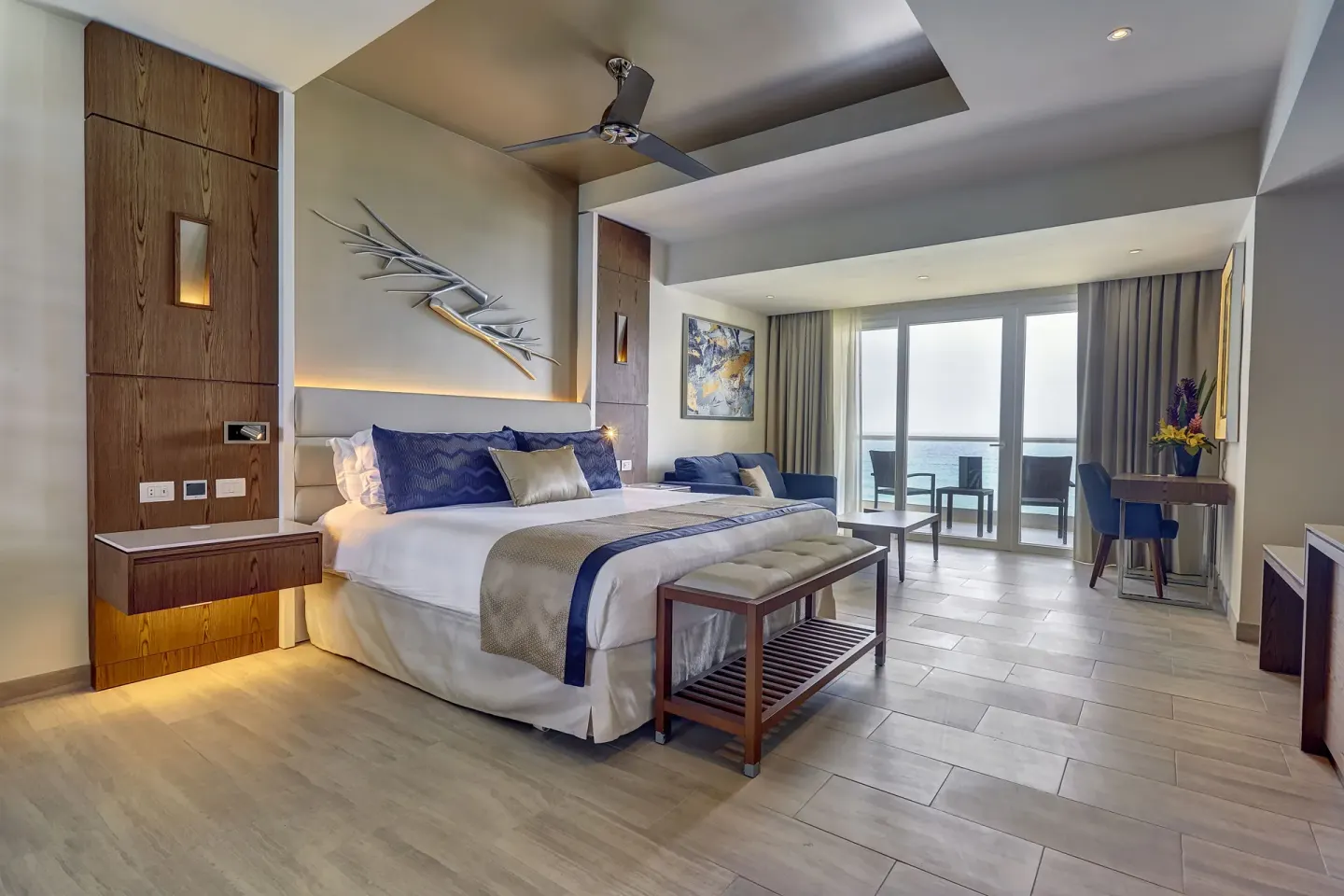Luxury Junior Suite Ocean Front king bed, sitting area, and balcony at Royalton CHIC Cancun.
