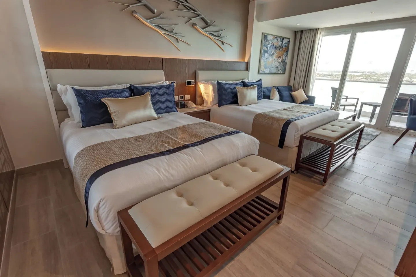 Two-bed Luxury Junior Suite Sunset View at Royalton CHIC Cancun with balcony doors.