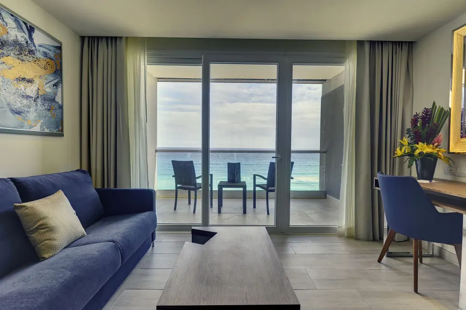 Oceanfront living area in a Presidential Suite at Royalton CHIC Cancun with balcony seating.