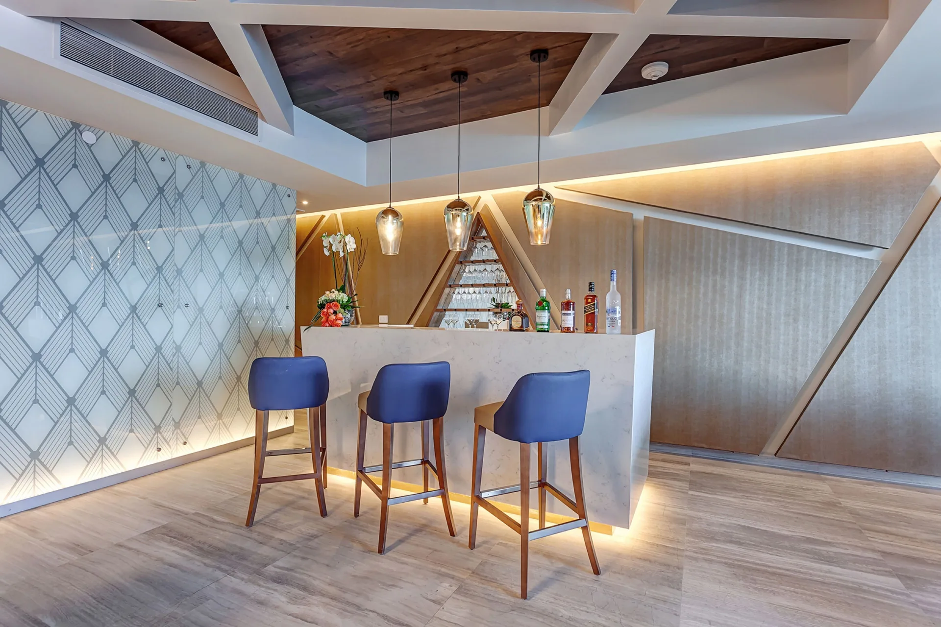 Private suite bar with blue stools in the Presidential Suite at Royalton CHIC Cancun.