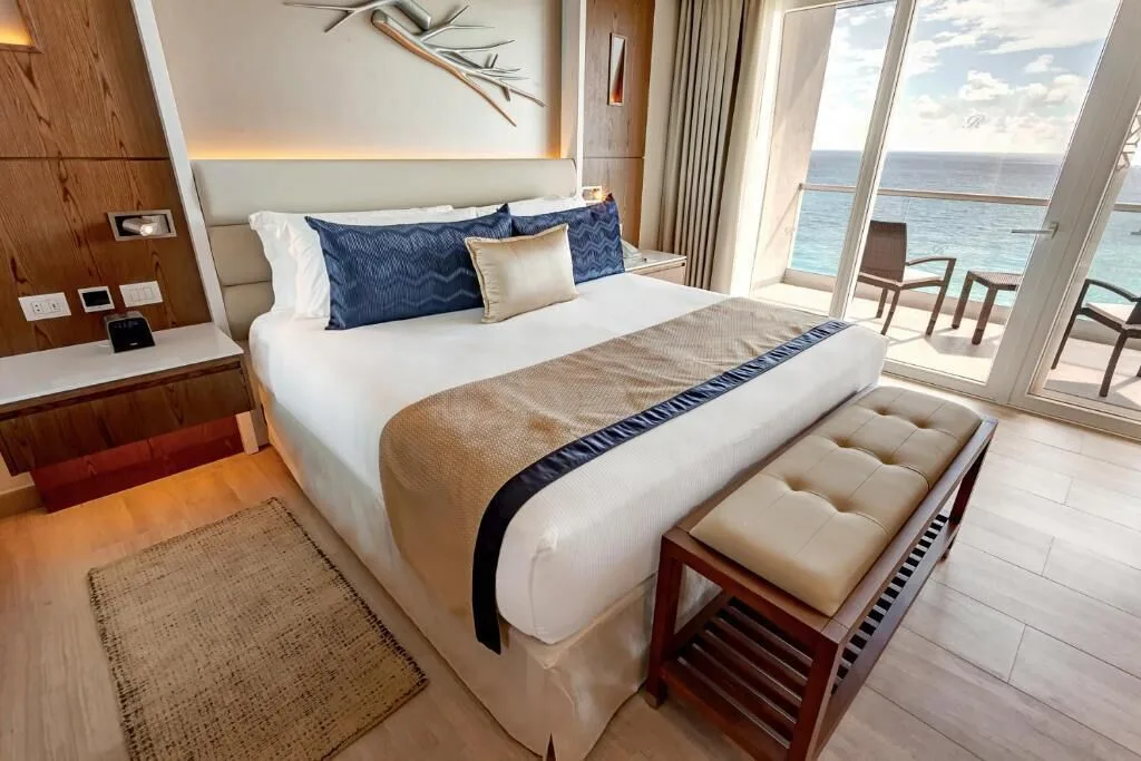 Luxury Suite Ocean Front king bed and balcony view at Royalton CHIC Cancun.