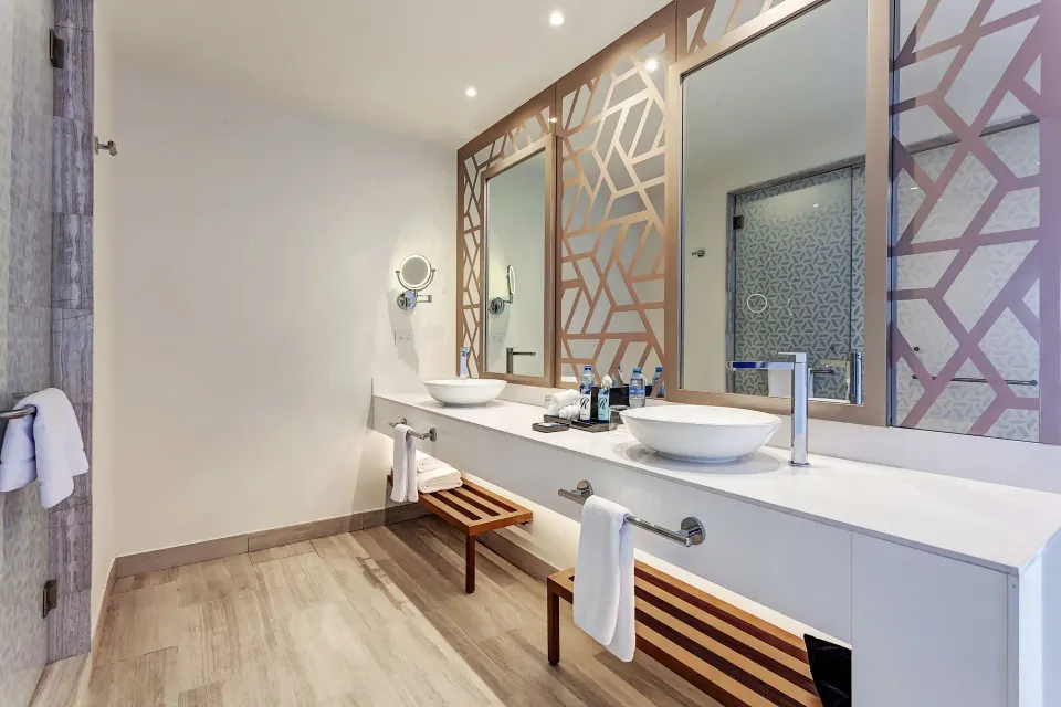 Luxury Suite Sunset View bathroom with dual vessel sinks at Royalton CHIC Cancun.