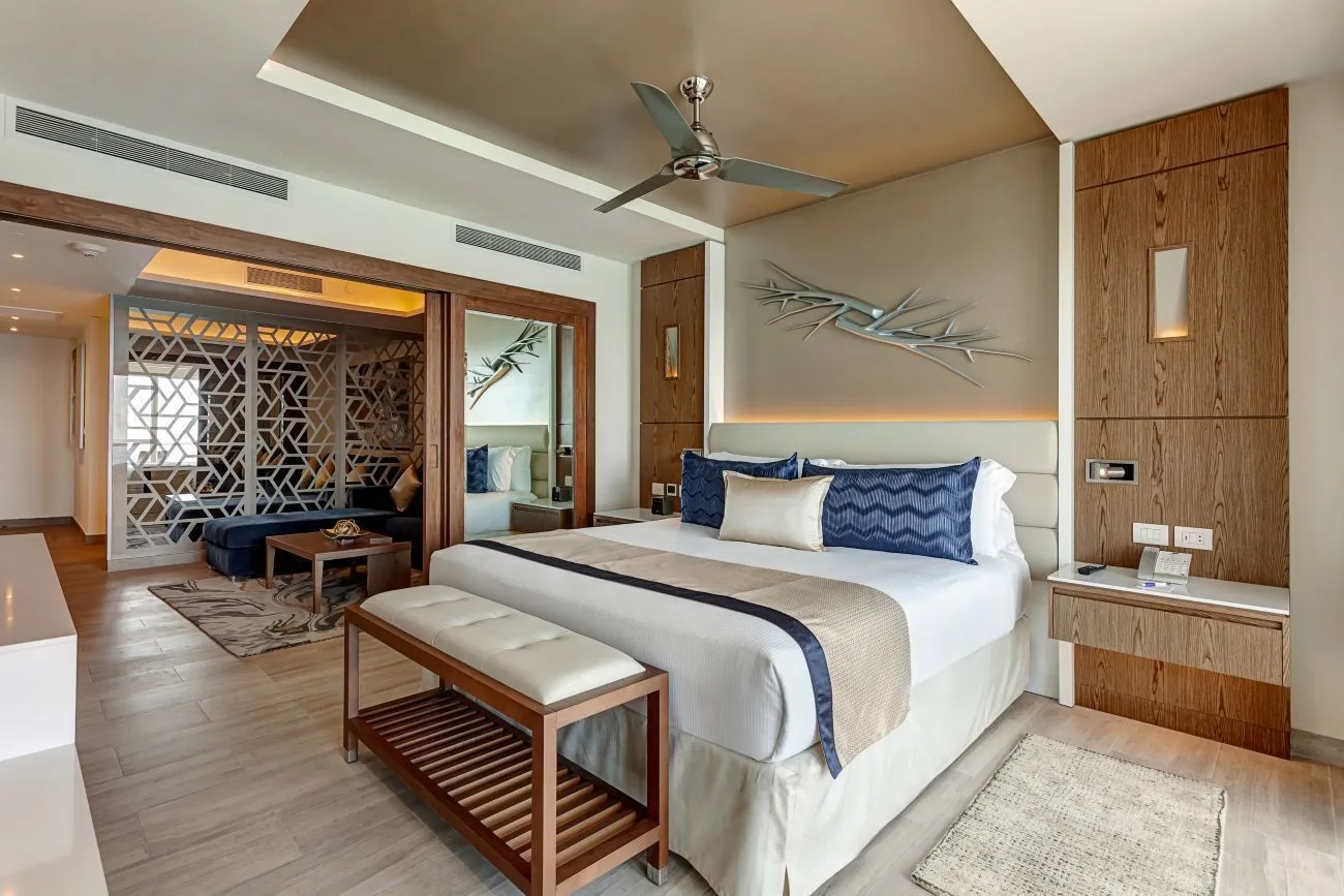 Luxury Suite Sunset View king bed and sitting area at Royalton CHIC Cancun.