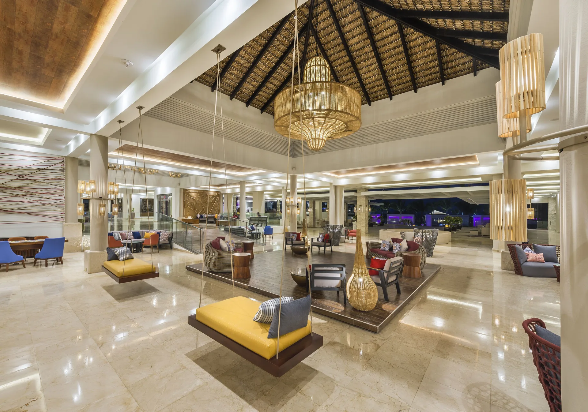 Bright lobby seating with hanging daybeds at Royalton CHIC Punta Cana Resort & Casino.