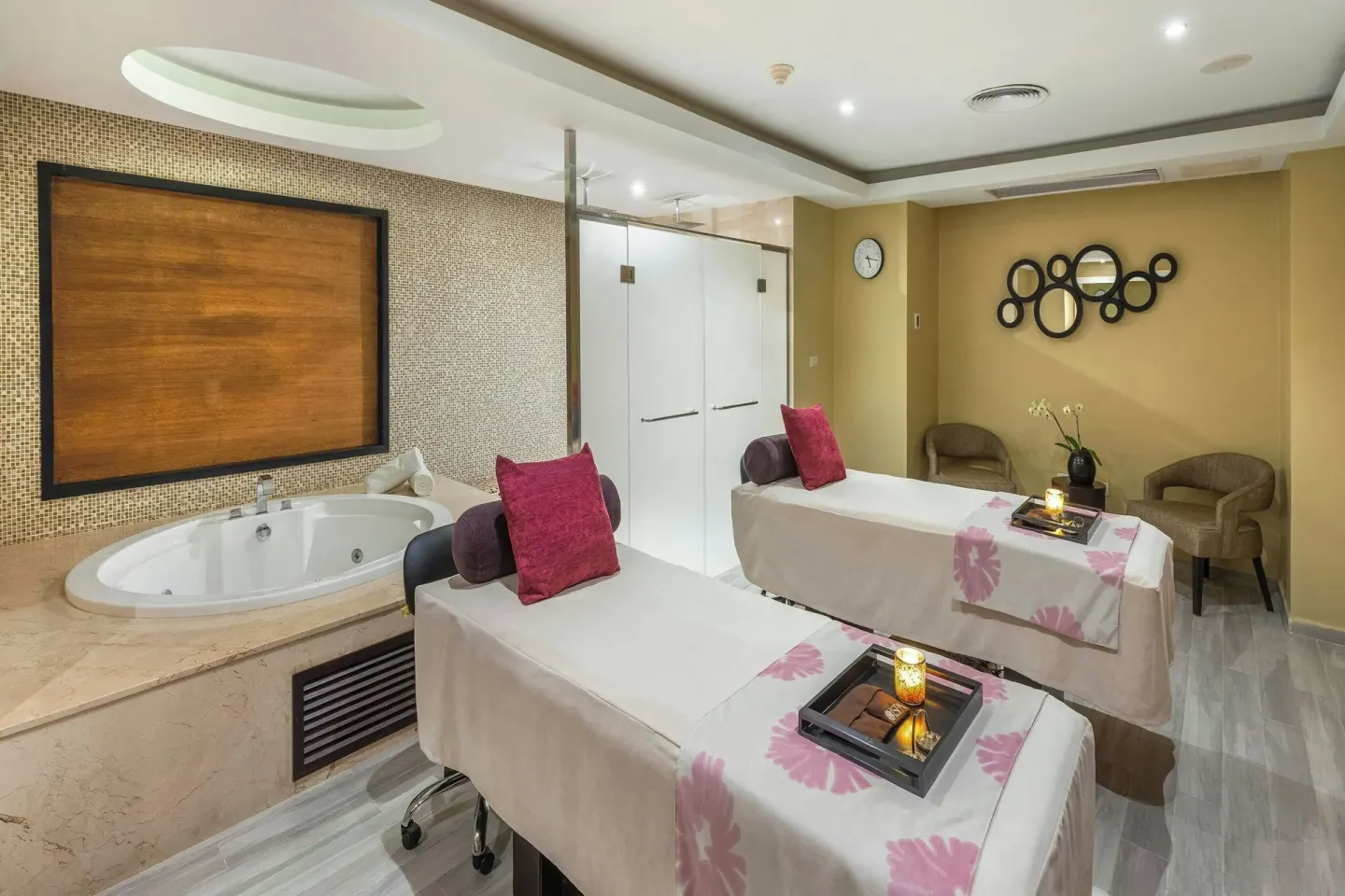 Couples massage room at Royalton CHIC Punta Cana Resort & Casino with two treatment beds and a tub.