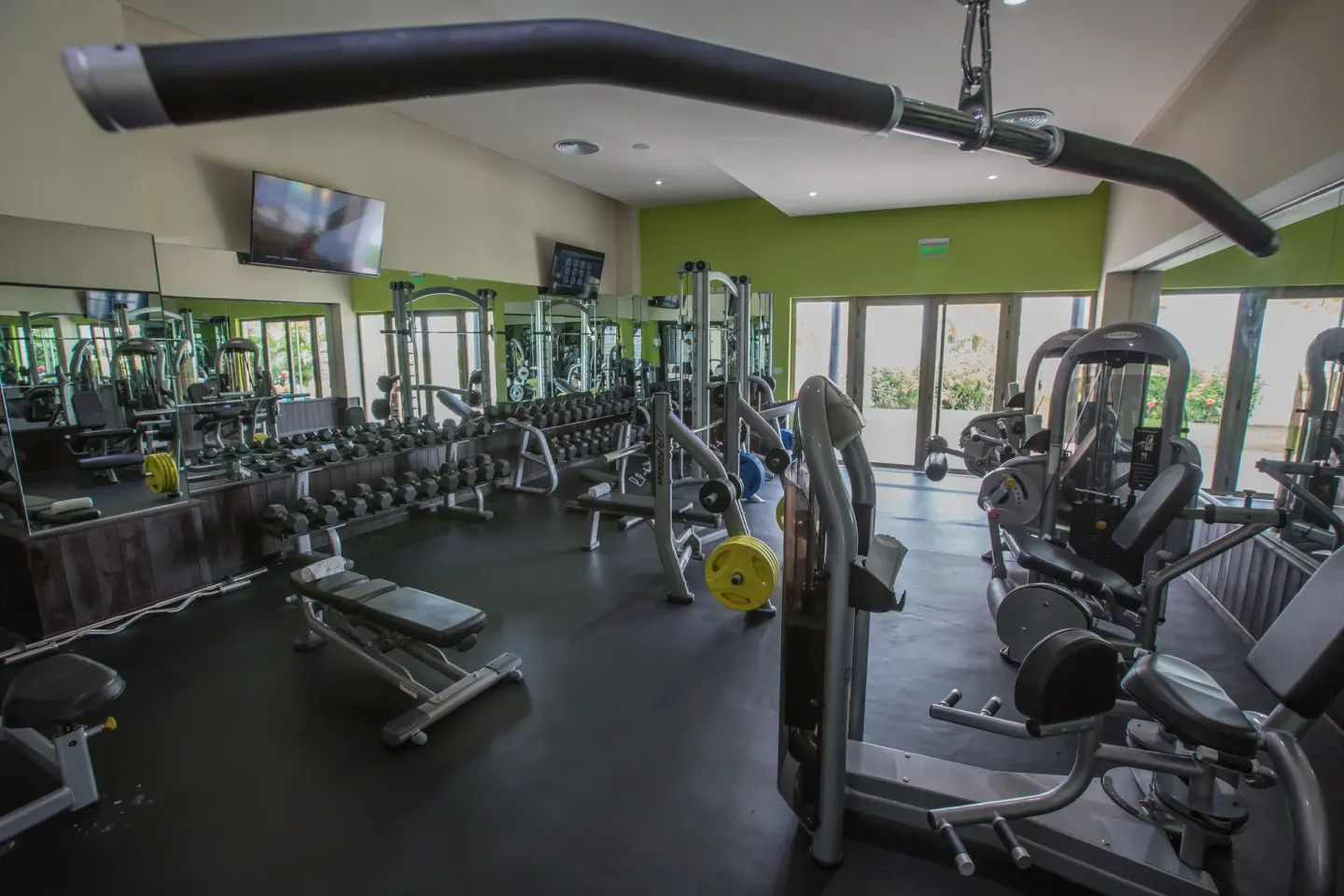Fitness center at Royalton CHIC Punta Cana Resort & Casino with weights, benches, and exercise machines.