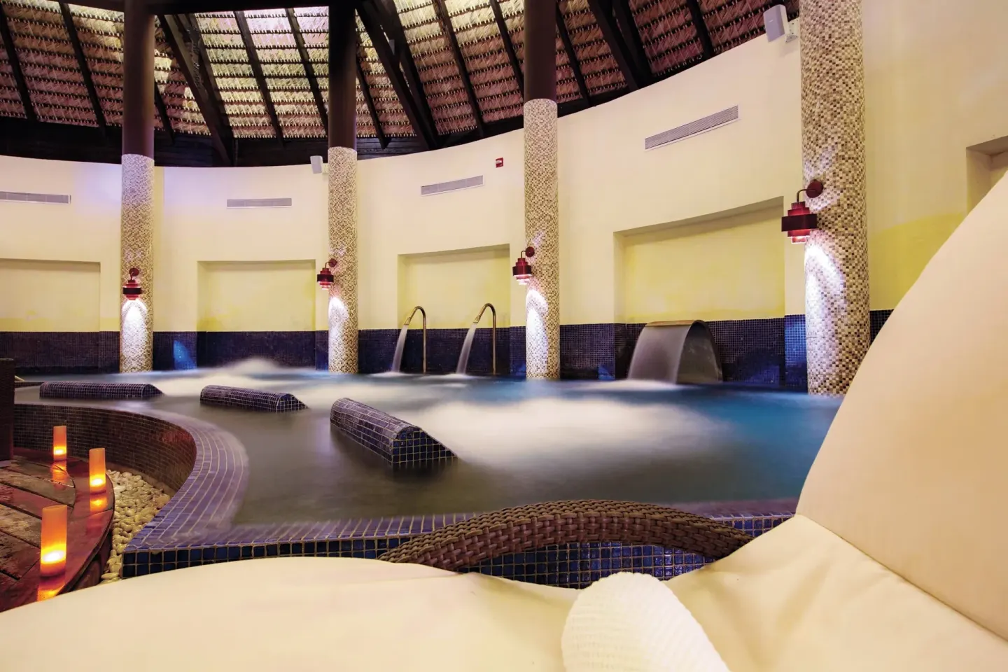 Indoor hydrotherapy pool with loungers at Royalton CHIC Punta Cana Resort & Casino.