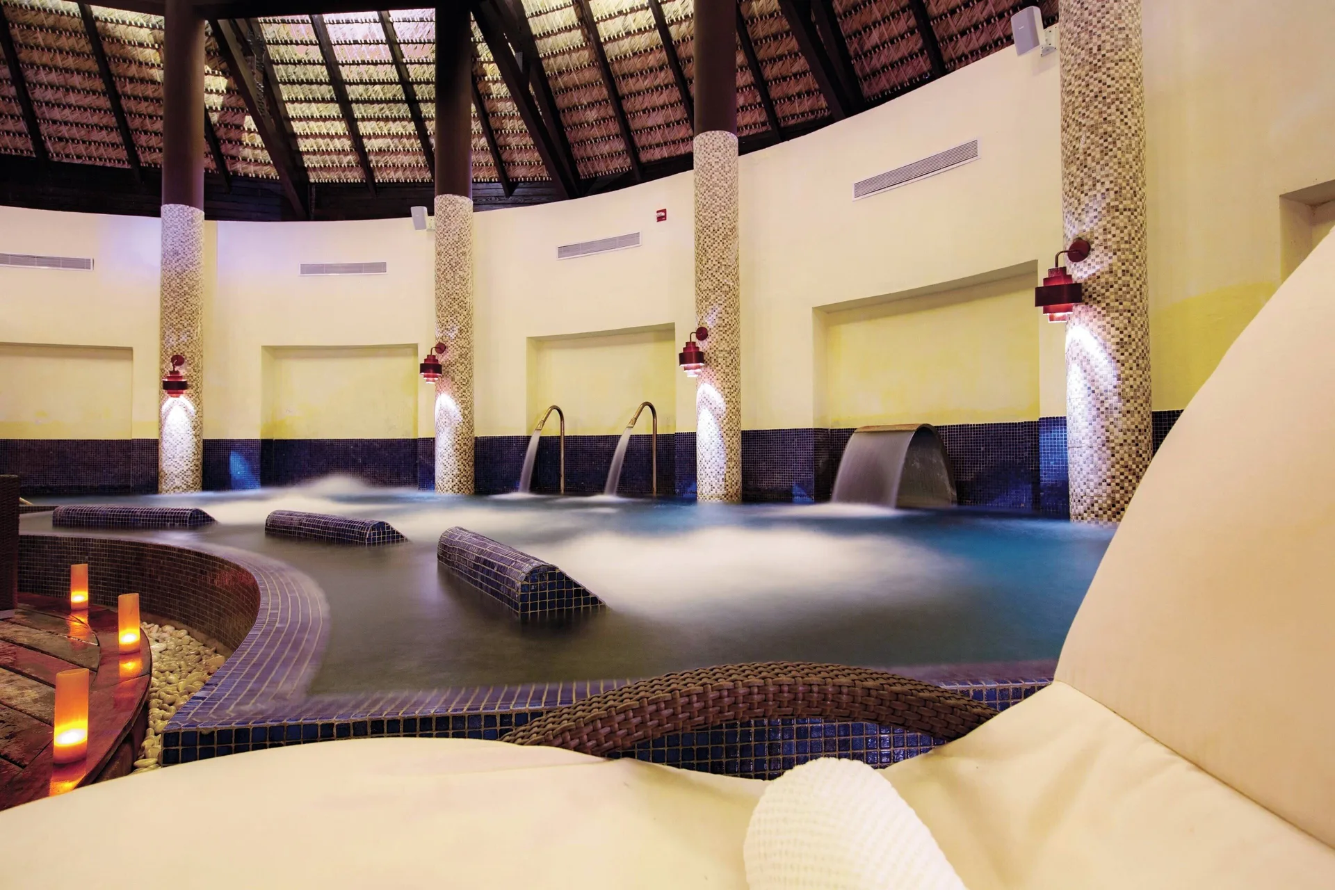 Indoor hydrotherapy pool with loungers at Royalton CHIC Punta Cana Resort & Casino.