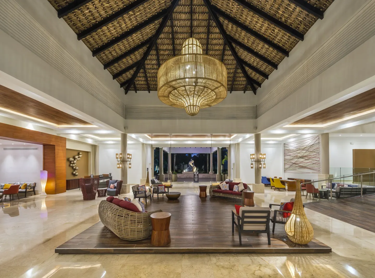 Open lobby lounge with thatched ceiling at Royalton CHIC Punta Cana Resort & Casino.