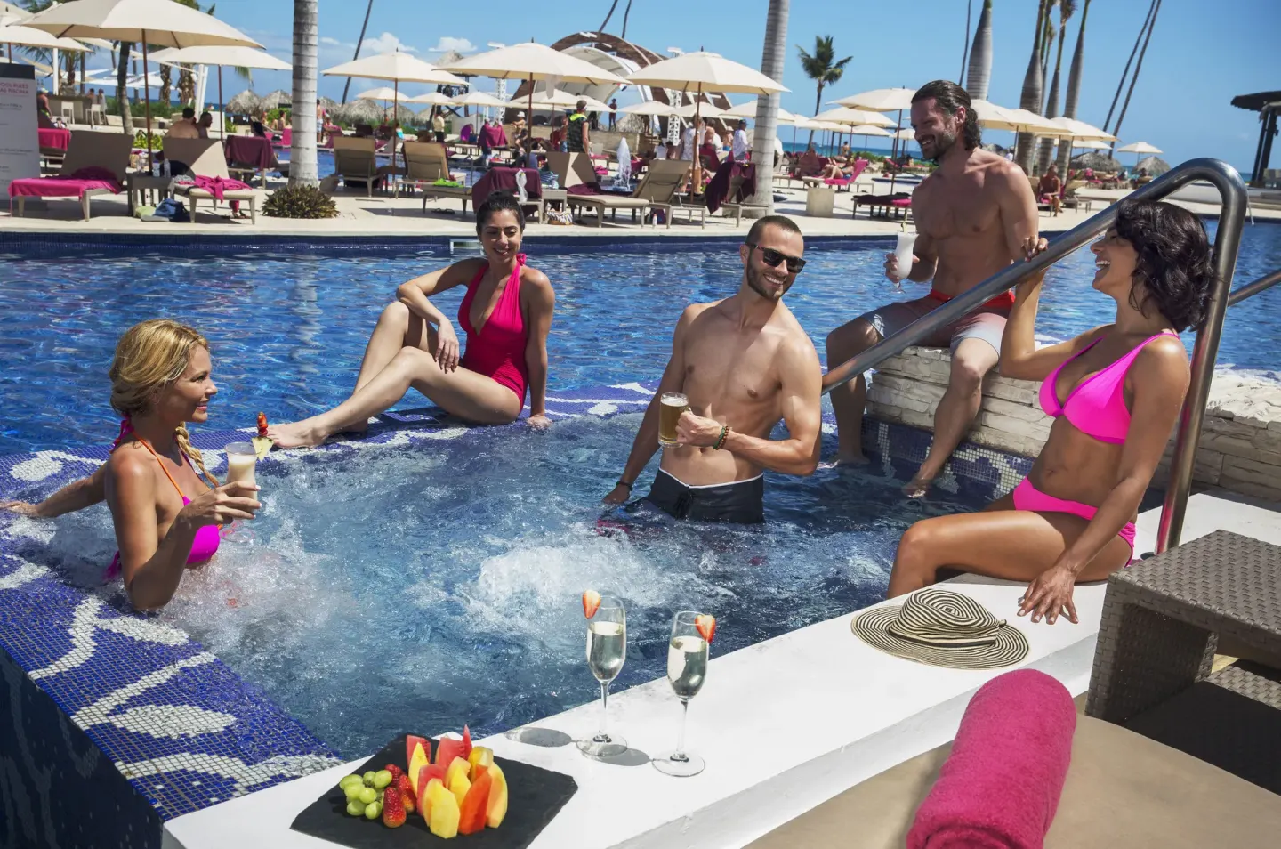 Guests socialize in a bubbling pool area at Royalton CHIC Punta Cana Resort & Casino.