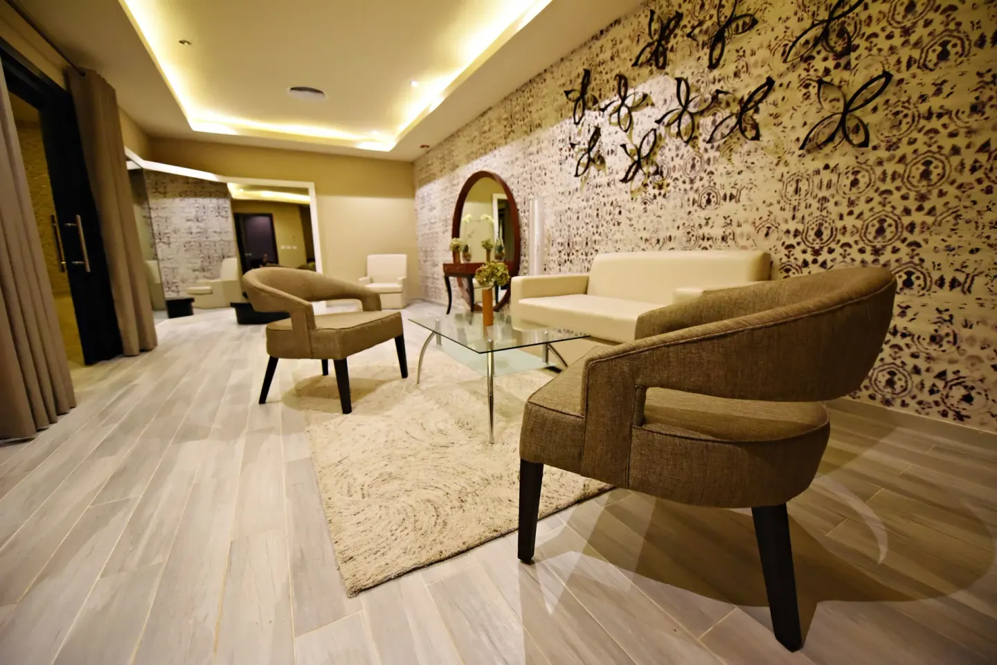 Spa lounge with sofas and patterned wall art at Royalton CHIC Punta Cana Resort & Casino.