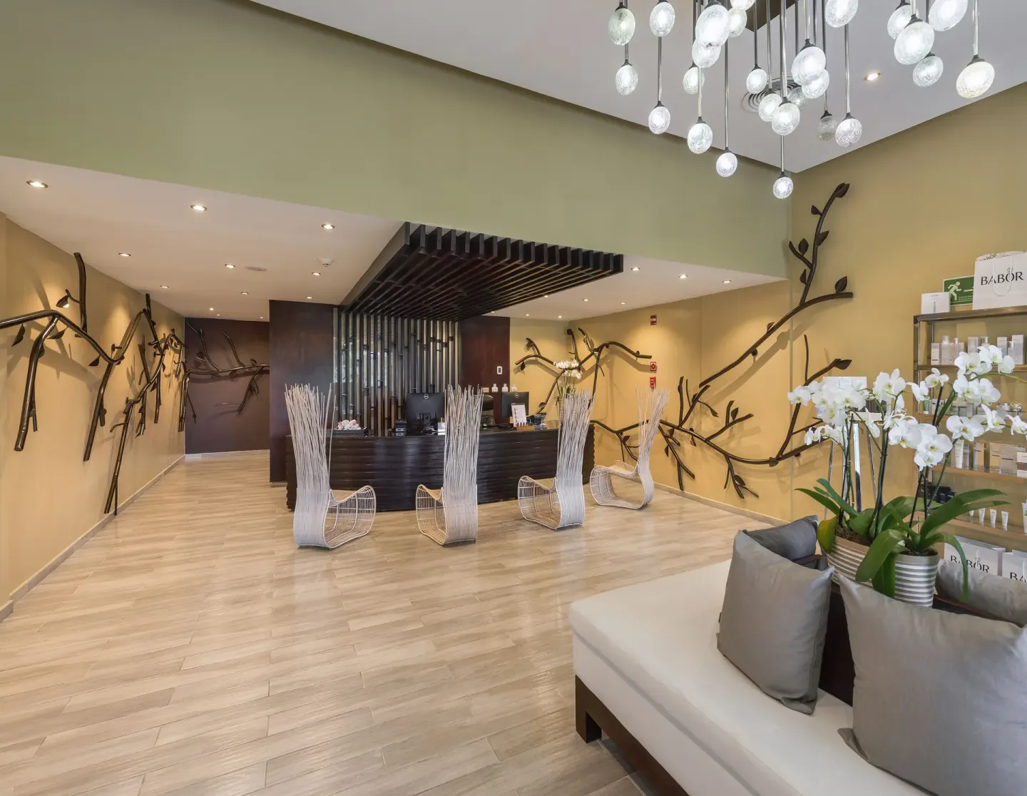 Spa reception with branch-like wall decor at Royalton CHIC Punta Cana Resort & Casino.