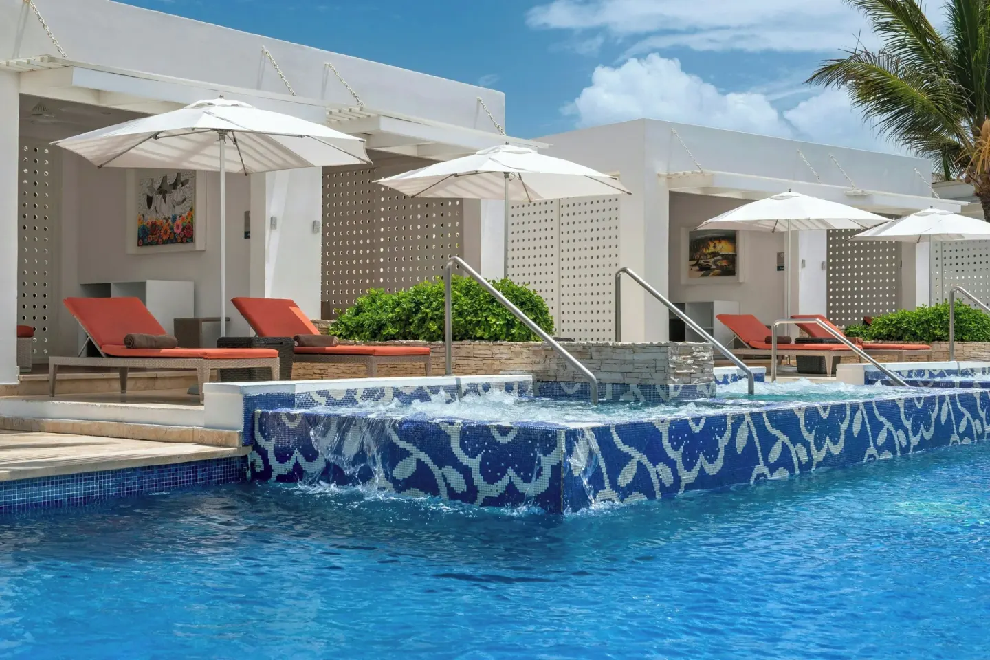 Swim-up cabanas with loungers and umbrellas at Royalton CHIC Punta Cana Resort & Casino.